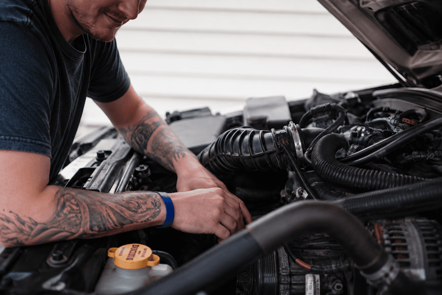 Mobile mechanic working on a car engine in Perth