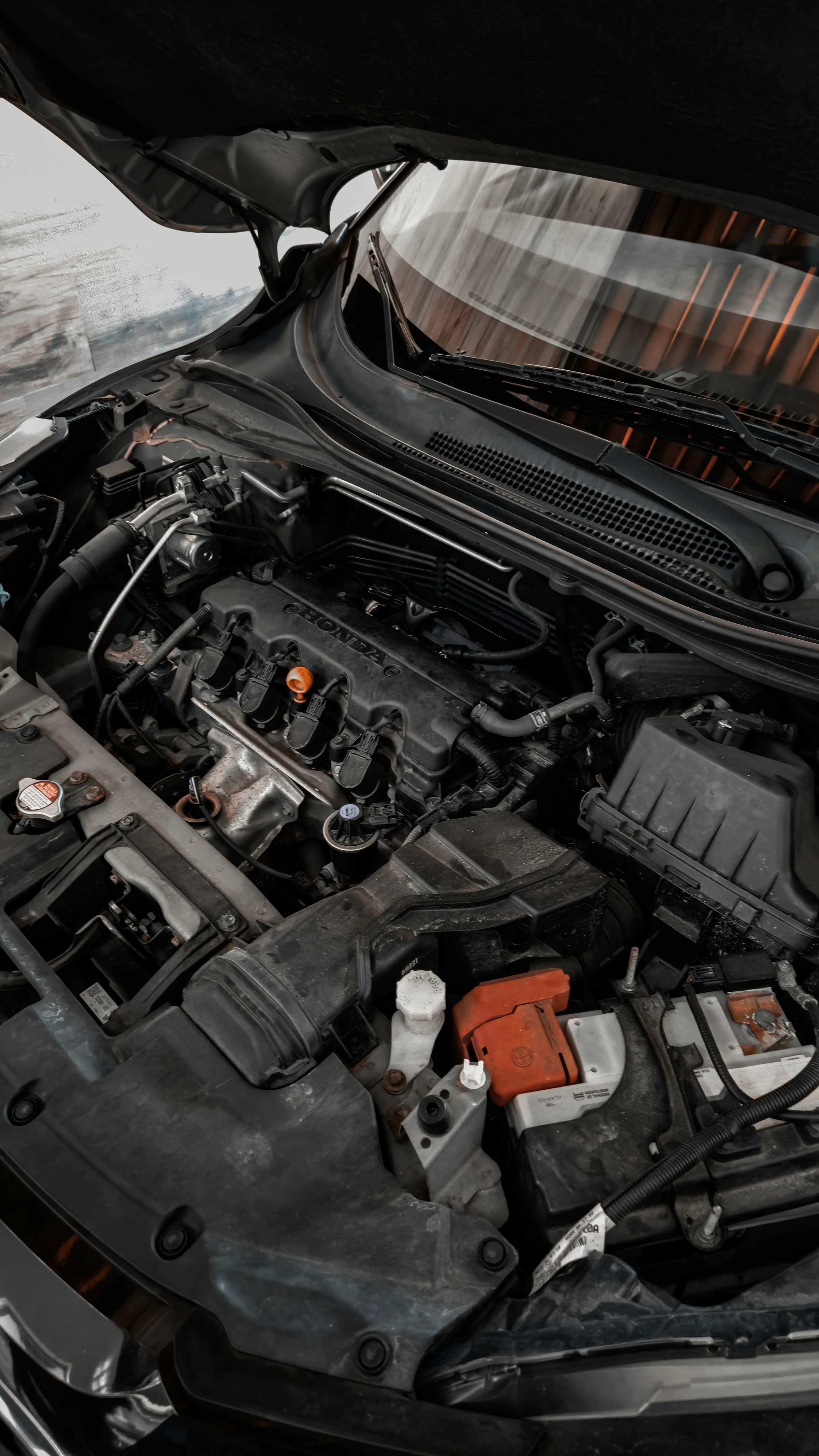 Mobile mechanic working on a car engine in Perth